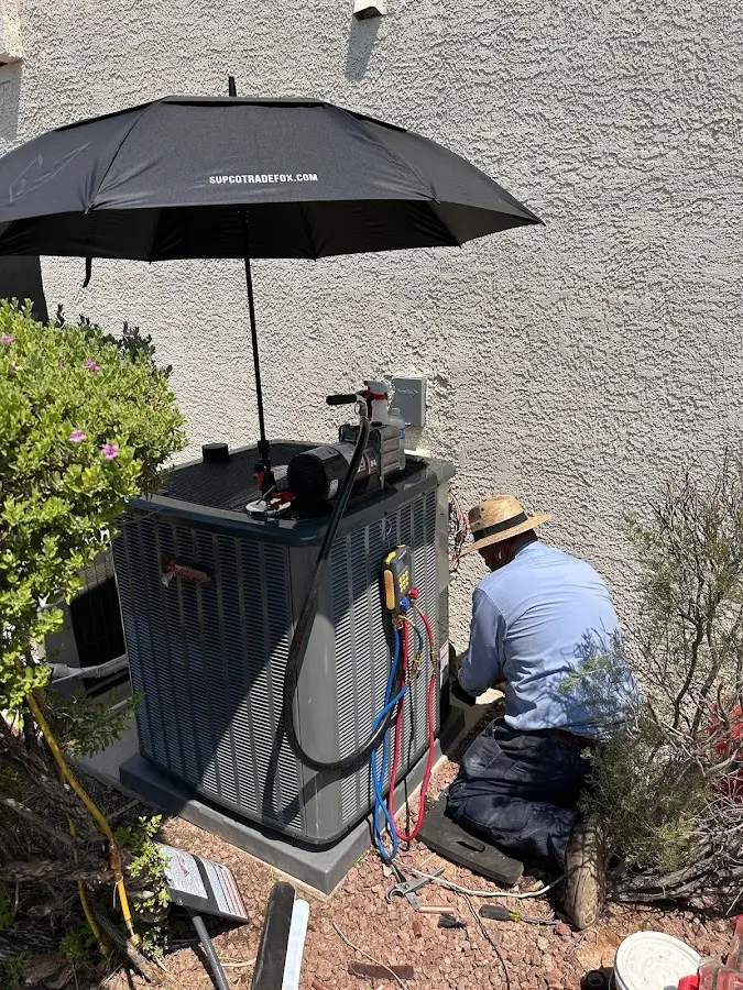 HVAC technician performing outdoor AC maintenance in Nevada