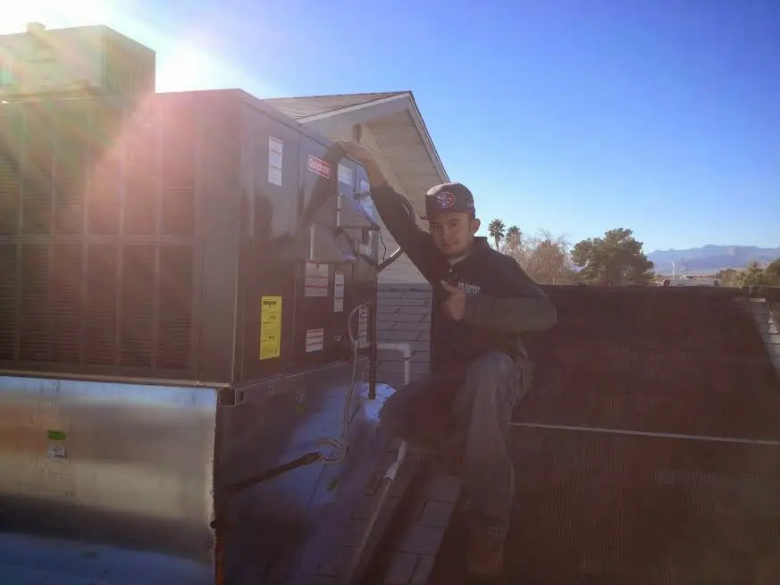 HVAC technician performing HVAC Inspection on a rooftop unit in Nevada